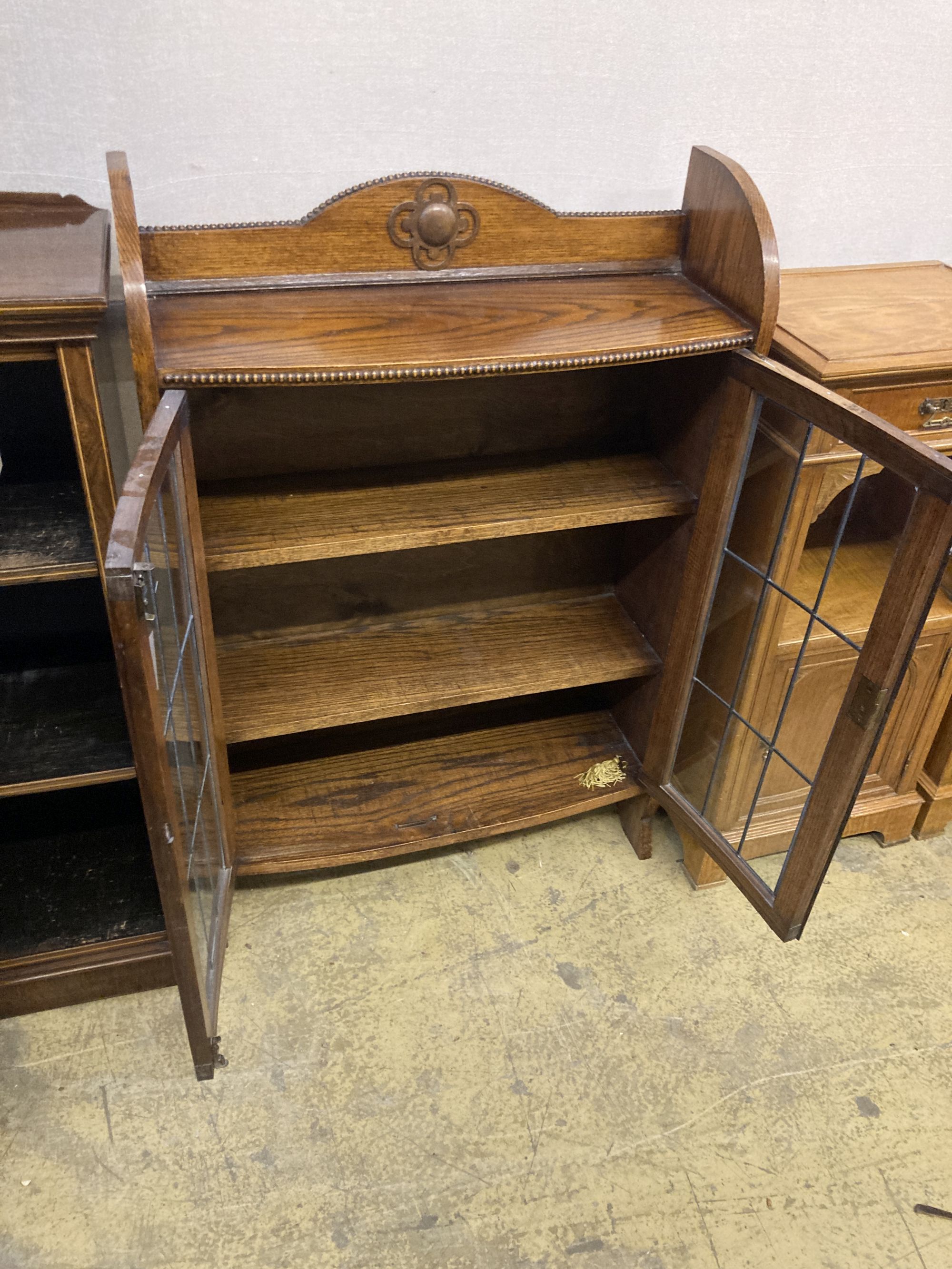 A 1920s oak bow front bookcase, length 73cm, width 26cm, height 110cm
